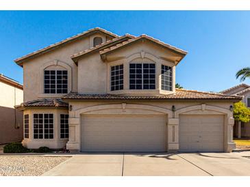 Two-story house with three-car garage and landscaped front yard at 553 S Meadows Dr, Chandler, AZ 85224