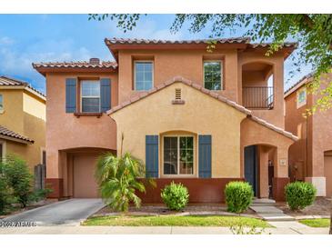 Two-story home with a neutral color palette and landscaped front yard at 7827 W Cypress St, Phoenix, AZ 85035