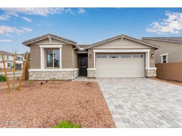 Charming single-story home with a two-car garage and desert landscaping at 8333 N 54Th Ln, Glendale, AZ 85302