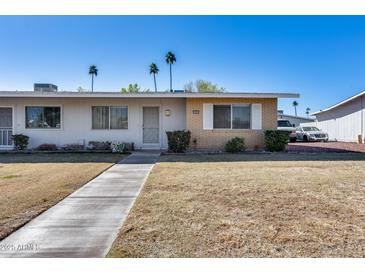 Single story home with brick facade and small front yard at 10863 W Thunderbird Blvd, Sun City, AZ 85351