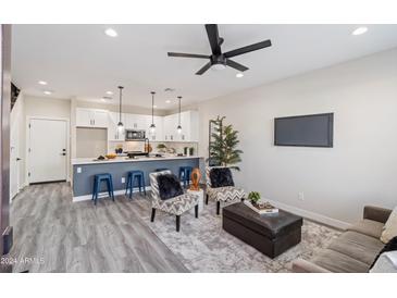 Open floor plan with modern kitchen island, stainless steel appliances, and cozy living area at 1642 E Monte Vista Rd # 4, Phoenix, AZ 85006