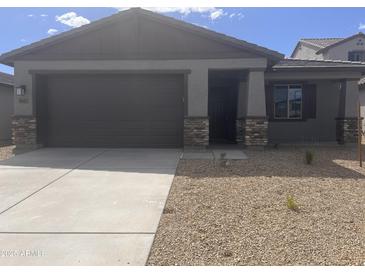 Charming single story home with a two car garage and low maintenance desert landscaping at 20622 N 226Th Ln, Surprise, AZ 85387