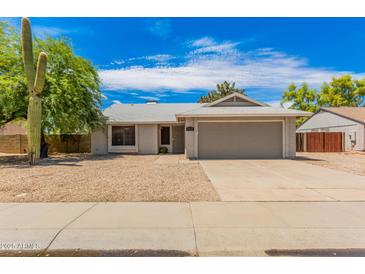 Single-story house with a gray garage door and desert landscaping at 5648 W Folley St, Chandler, AZ 85226