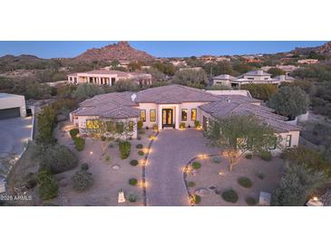 Stunning desert home with a tile roof, stone accents, and a landscaped yard at 26475 N 106Th Way, Scottsdale, AZ 85255