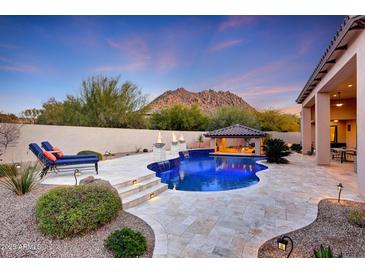 Inviting pool and spa with a covered patio and mountain views at 26475 N 106Th Way, Scottsdale, AZ 85255
