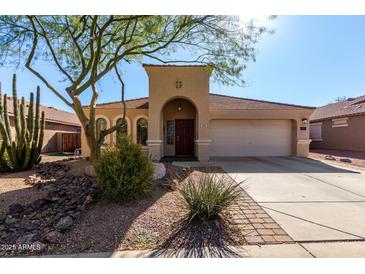 One-story house with desert landscaping and a two-car garage at 695 E Mule Train Trl, San Tan Valley, AZ 85143