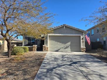 Single-story home with a two-car garage and landscaped front yard at 10815 S 175Th Dr, Goodyear, AZ 85338