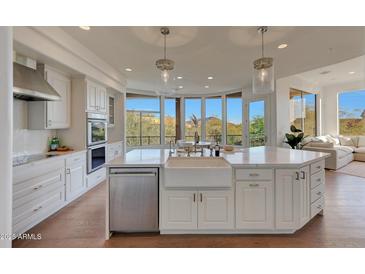 Modern white kitchen with a large island and ample counter space at 12411 N 133Rd Pl, Scottsdale, AZ 85259