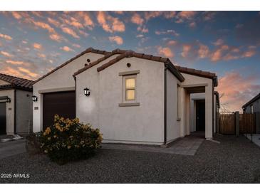 Single story home with a two car garage and desert landscaping at 13616 W Sandridge Dr, Sun City West, AZ 85375