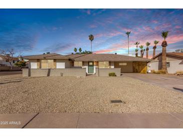 Charming single-story home with landscaped yard and a large driveway at 3046 W Palmaire Ave, Phoenix, AZ 85051