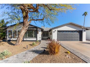 Updated single story home with gray accents and a landscaped front yard at 4356 E Coconino St, Phoenix, AZ 85044