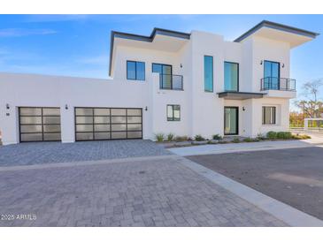 Modern two-story home with attached three-car garage and paved driveway at 100 W Northern Ave # 7, Phoenix, AZ 85021