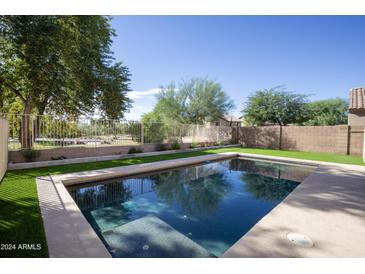 Inviting backyard pool with artificial turf at 11967 W Vernon Ave, Avondale, AZ 85392