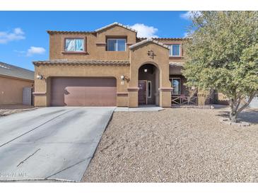 Two-story house with brown exterior, attached garage, and landscaped yard at 1923 N Cocoa Ct, Casa Grande, AZ 85122