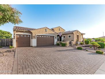 Beautiful home exterior with three car garage and paver driveway at 2827 E Bellerive Dr, Gilbert, AZ 85298