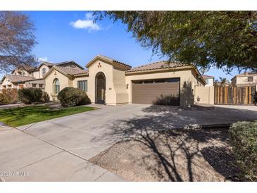 Single-story home with a two-car garage and landscaped front yard at 2832 E Flower St, Gilbert, AZ 85298