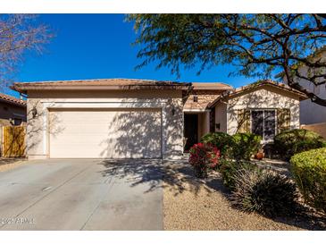 Single-story home with a two-car garage and well-manicured landscaping at 5512 W Cavedale Dr, Phoenix, AZ 85083