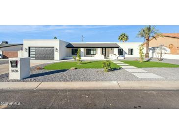 Modern house exterior with landscaped lawn and walkway at 9626 N 17Th Pl, Phoenix, AZ 85020
