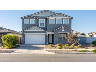 Two-story home with gray exterior, white garage door, and landscaped front yard at 9814 E Sunspot Dr, Mesa, AZ 85212