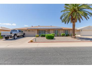 Ranch-style home with solar panels and landscaped yard at 11030 W Pleasant Valley W Rd, Sun City, AZ 85351