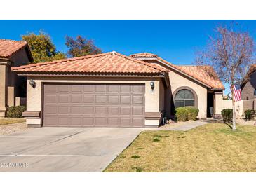 Attractive single-story home with a two-car garage and well-manicured lawn at 1350 W Seascape Dr, Gilbert, AZ 85233