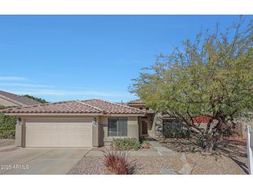 Single-story home with a two-car garage and mature landscaping at 1656 E Montoya Ln, Phoenix, AZ 85024
