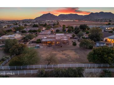 Aerial view of a beautiful home with a pool and large backyard, set against a mountain backdrop at 20918 E Orchard Ln, Queen Creek, AZ 85142
