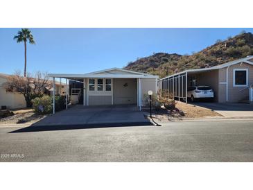 Mobile home exterior with carport and mountain views at 2233 E Behrend Dr # 197, Phoenix, AZ 85024