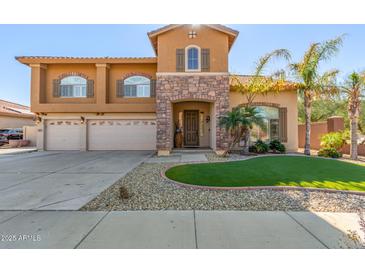Two-story house with three-car garage and landscaped front yard at 2415 W Desperado Way, Phoenix, AZ 85085