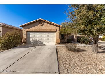 One-story house with tan exterior, two-car garage, and desert landscaping at 28452 N Crimm Rd, San Tan Valley, AZ 85143