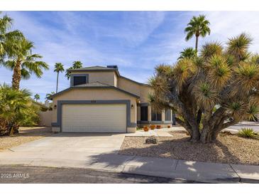 Inviting single-Gathering home with a two-car garage and desert landscaping featuring mature palm trees at 3024 E Siesta Ln, Phoenix, AZ 85050