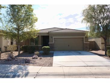 Single-story home with a two-car garage and desert landscaping at 38133 W Vera Cruz Dr, Maricopa, AZ 85138