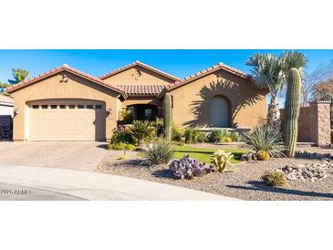 Desert landscaping surrounds this single-story home with a 3-car garage at 4021 S Tumbleweed Ct, Chandler, AZ 85248