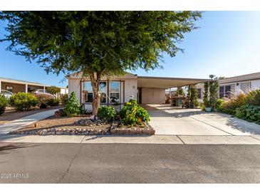 Mobile home with carport, landscaping, and spacious yard at 437 E Germann Rd # 24, San Tan Valley, AZ 85140
