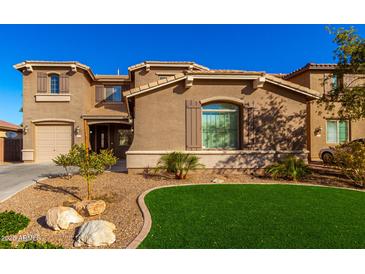 Two-story house with landscaped lawn and attached two-car garage at 472 W Dragon Tree Ave, Queen Creek, AZ 85140