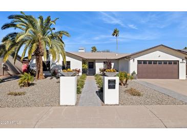 Beautiful single-story home with landscaped front yard and a two-car garage at 8856 E Altadena Ave, Scottsdale, AZ 85260