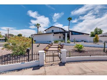 Stunning mid-century modern home with landscaped yard and walkway at 1401 W Ocotillo Rd, Phoenix, AZ 85013