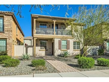 Two-story home with balcony, landscaped yard, and brick pathway at 29460 N 123Rd Gln, Peoria, AZ 85383