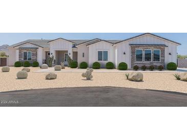 Beautiful farmhouse exterior with landscaping and desert accents at 3640 W Josiah Trl, Queen Creek, AZ 85144