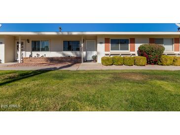 Front view of a ranch style home with well-manicured lawn at 9459 N 111Th Ave, Sun City, AZ 85351