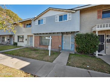 Two-story townhome with gray siding and a small front yard at 1307 N 44Th St, Phoenix, AZ 85008