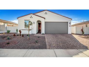 Single-story home with gray garage door and desert landscaping at 17765 W Silverwood Dr, Goodyear, AZ 85338