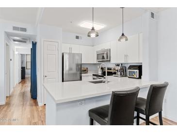 Modern kitchen with stainless steel appliances and white cabinetry at 20100 N 78Th Pl # 2091, Scottsdale, AZ 85255