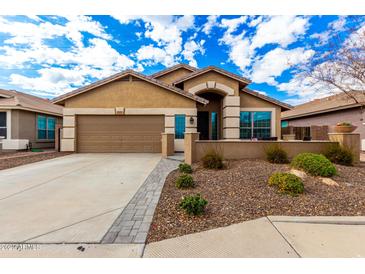 One-story house with a two-car garage and landscaped front yard at 20472 N 90Th Ln, Peoria, AZ 85382