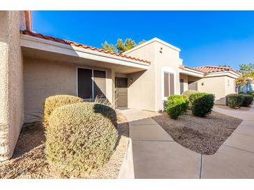 Inviting exterior of condo with well-manicured landscaping and walkway at 2929 W Yorkshire Dr # 1060, Phoenix, AZ 85027