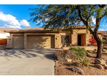 Tan house with stone accents, two-car garage, and desert landscaping at 4119 S Las Villa Way, Gold Canyon, AZ 85118