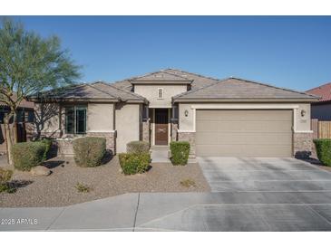 Single-story home with a two-car garage and well-manicured landscaping at 7332 W Quail Track Dr, Peoria, AZ 85383