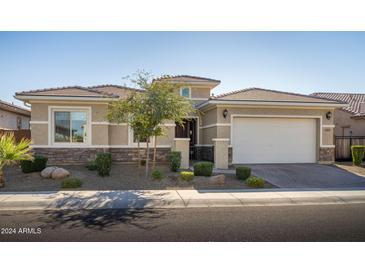 Single-story home with a two-car garage and desert landscaping at 3421 E Daley Ln, Phoenix, AZ 85050