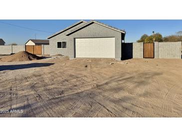 New construction home with attached garage and wood fence at 3720 N Del Monte Dr, Eloy, AZ 85131