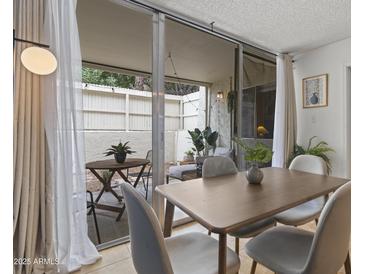 Bright dining area with patio access and modern table at 7625 E Camelback Rd # A108, Scottsdale, AZ 85251